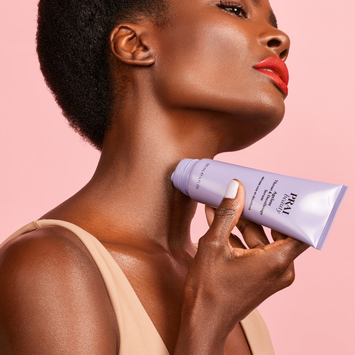 woman using PRAI Beauty skincare