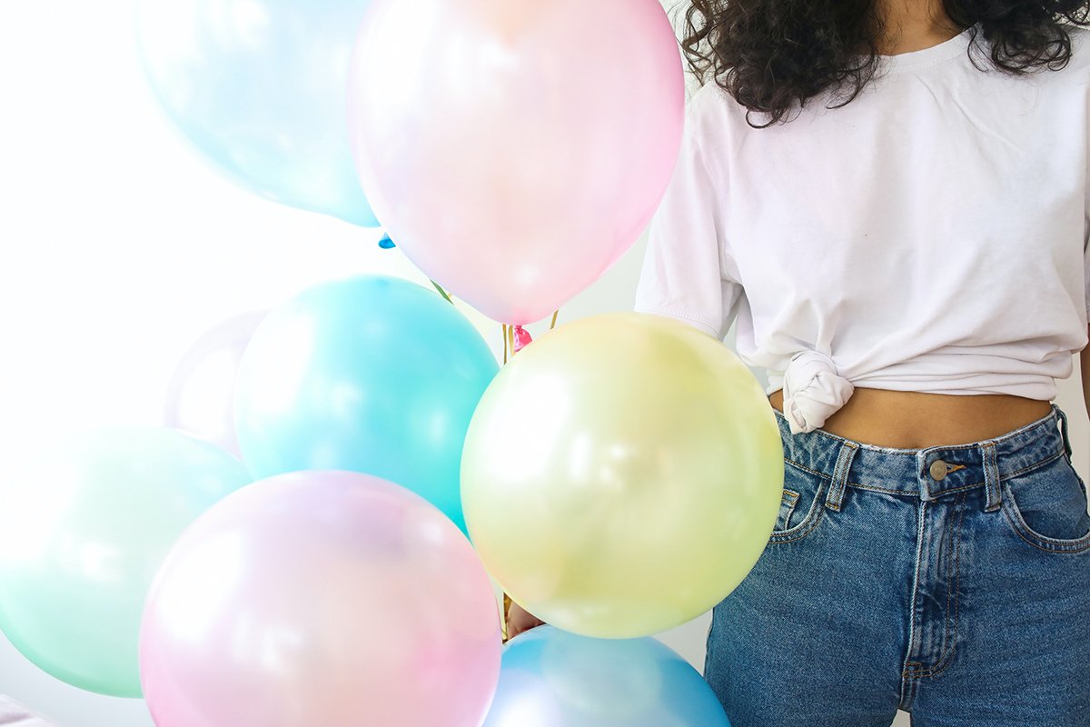 woman with balloons, celebrating june 2023 winners