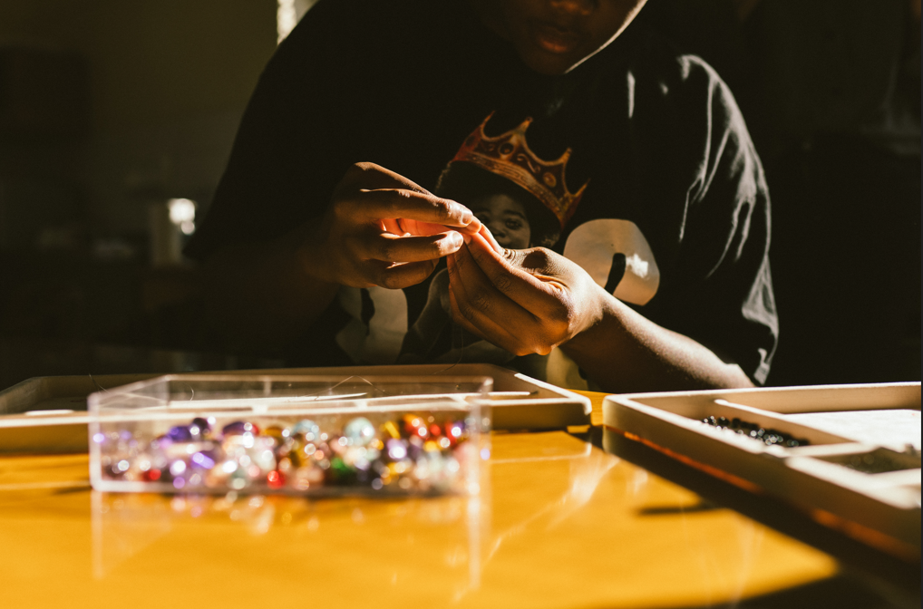 man putting together Black Betty and the kolisi foundation jewellery collection