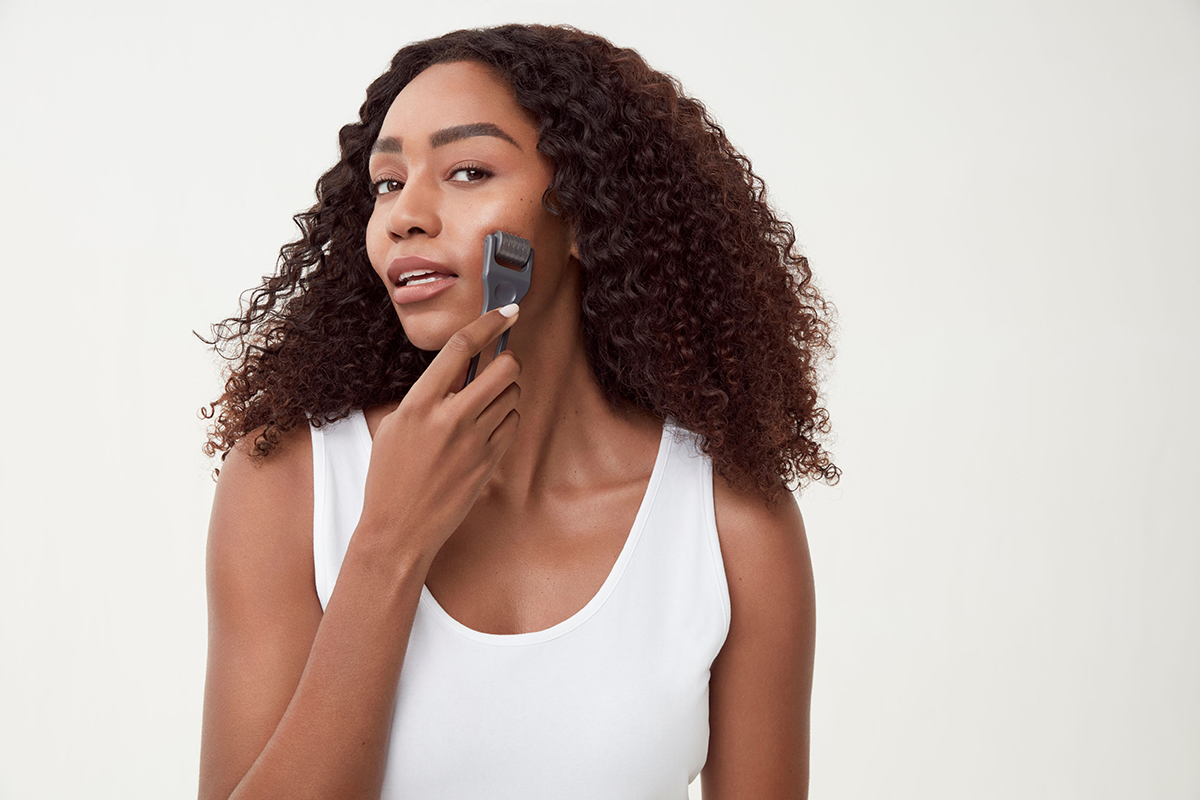 woman micro-needling her face