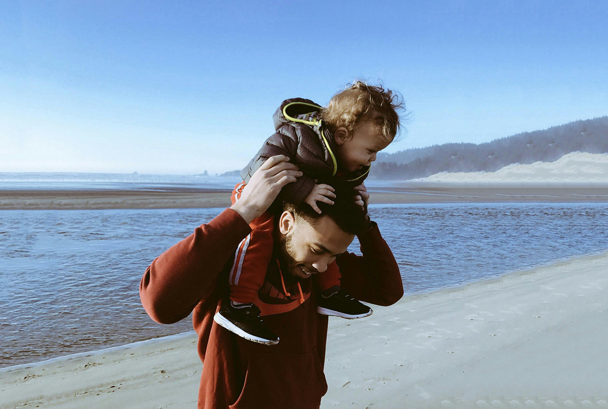 father's day image showing dad carrying son on his shoulders