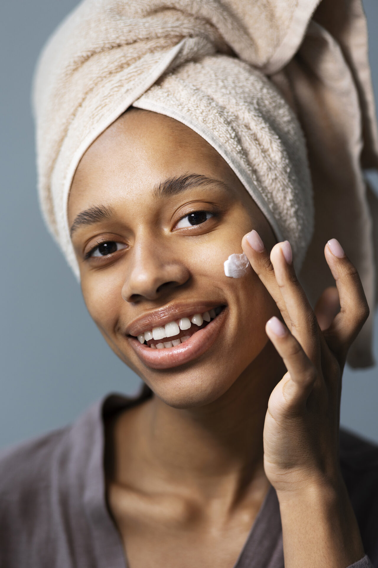 Top Hacks to Summer-Proof Your Skin 2 woman using facial cleanser for summer glow