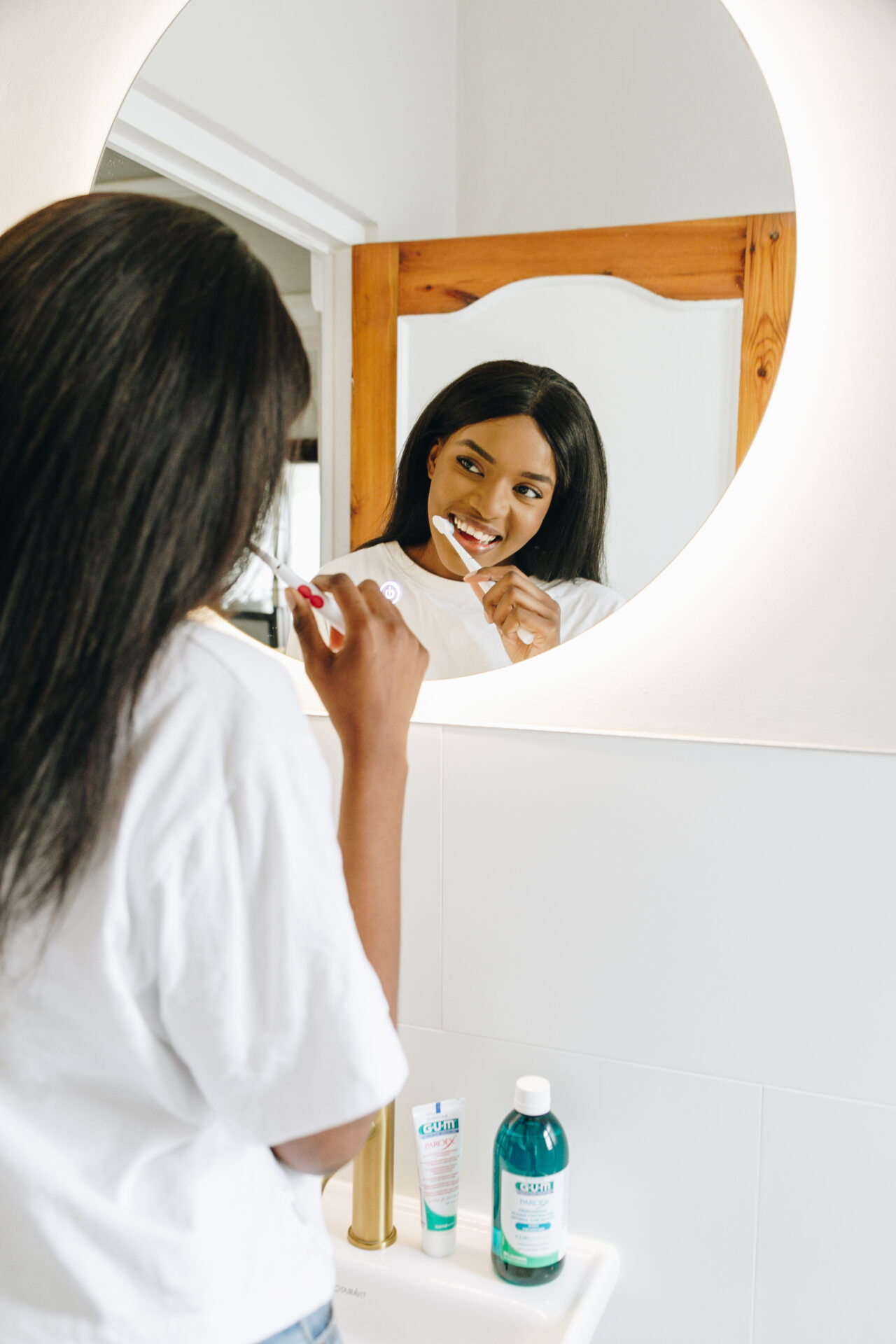 Win GUM oral care products this National Fresh Breath Month 1 woman brushing teeth with gum oral care products