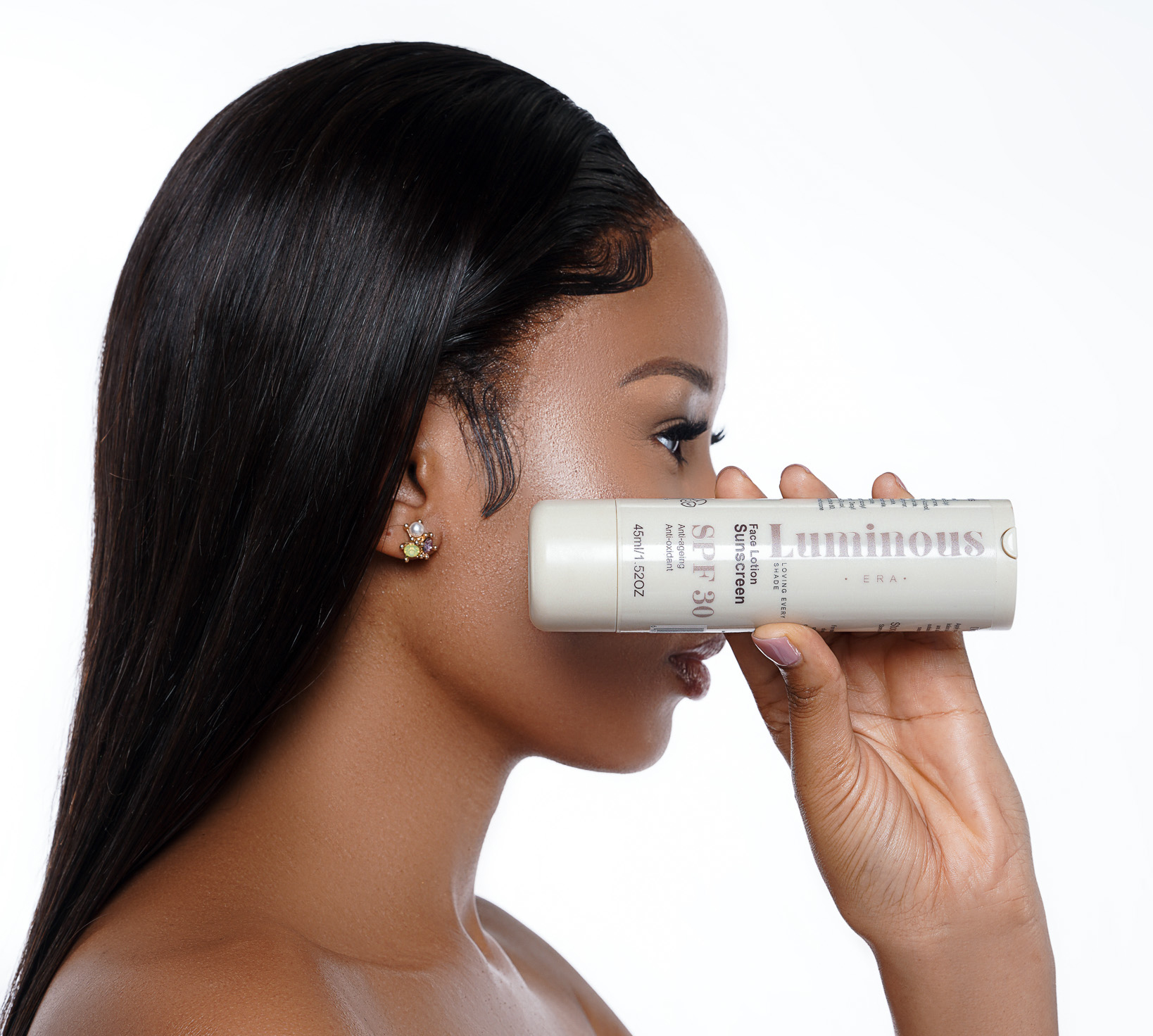 Woman shows Luminous Era SPF30 Sunscreen