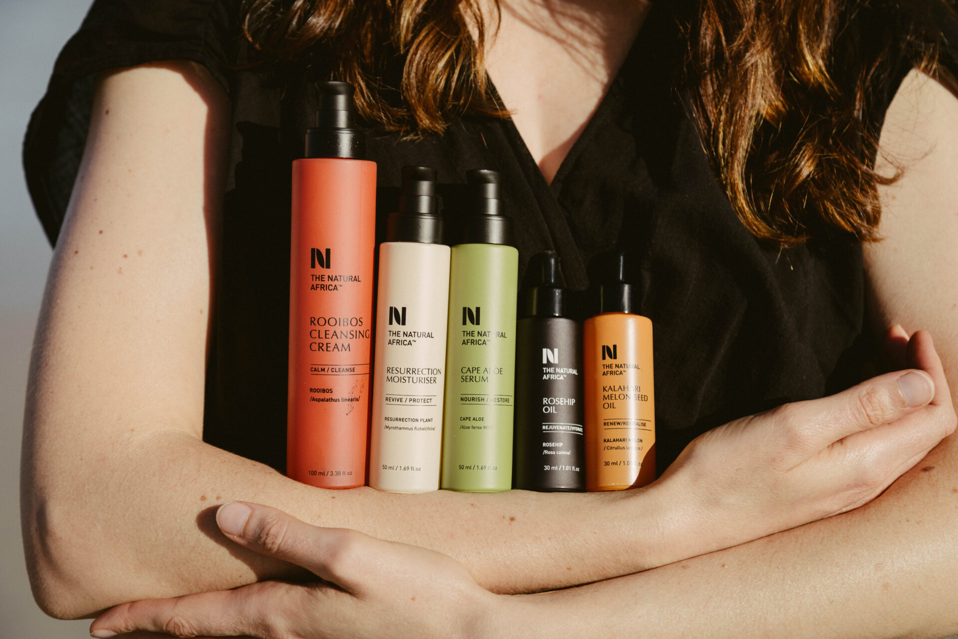 woman holding the natural africa ultimate glow set of products