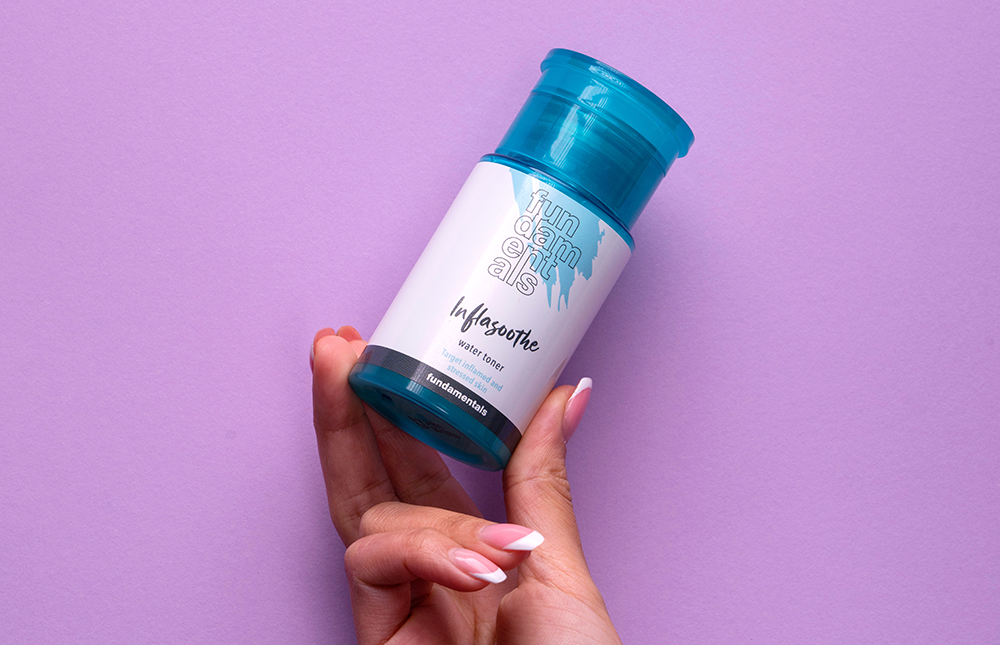 hand holding fundamentals inflasoothe skincare product