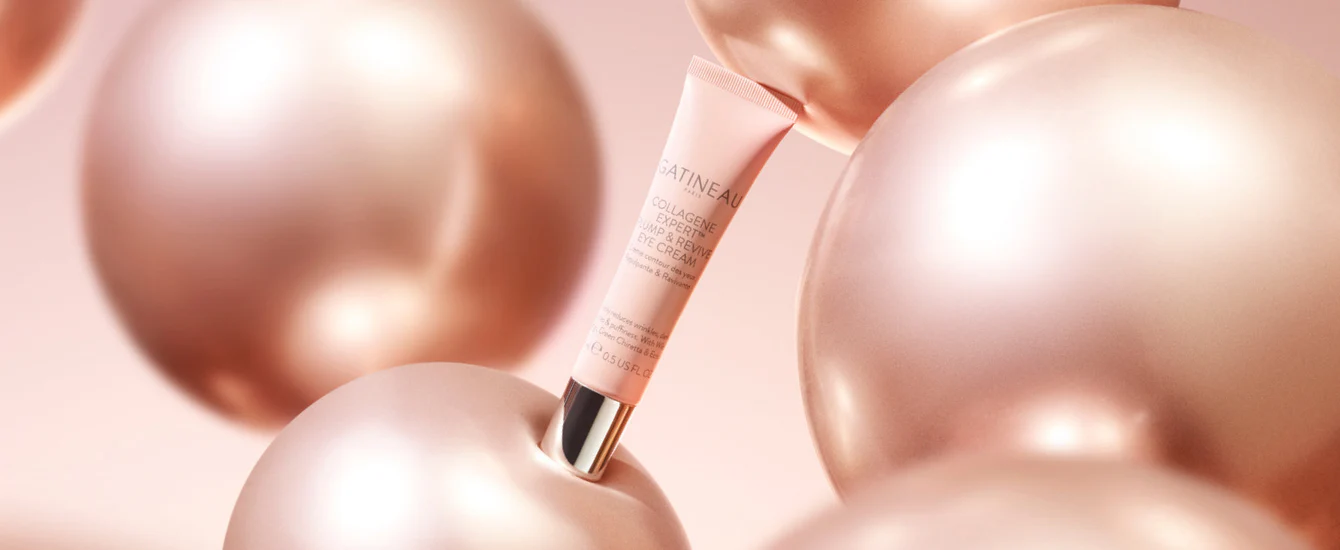 Introducing Gatineau Collagene Expert™ Plump & Revive Eye Cream 2 Gatineau Collagene Expert Eye cream among glossy pink spheres.
