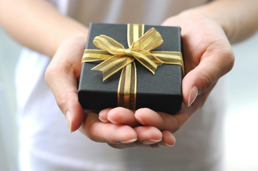 Hands holding a small gift box