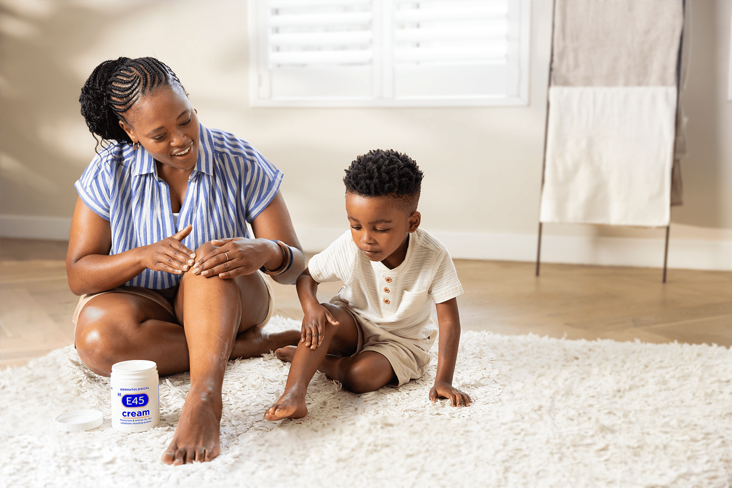 Mother and son applying E45 Cream