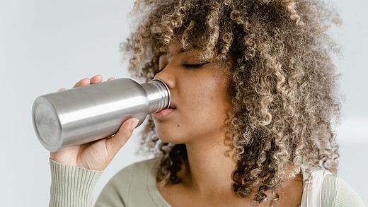 woman drinking water to combat winter dehydration
