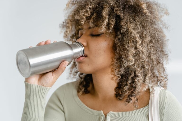 woman drinking water to combat winter dehydration